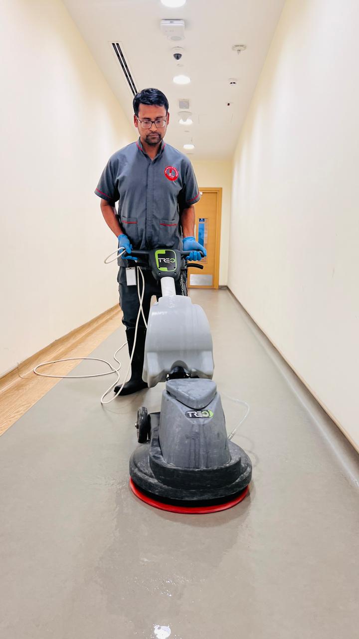 A professional cleaner from Libra Group cleaning the floor during deep cleaning services in Dubai.