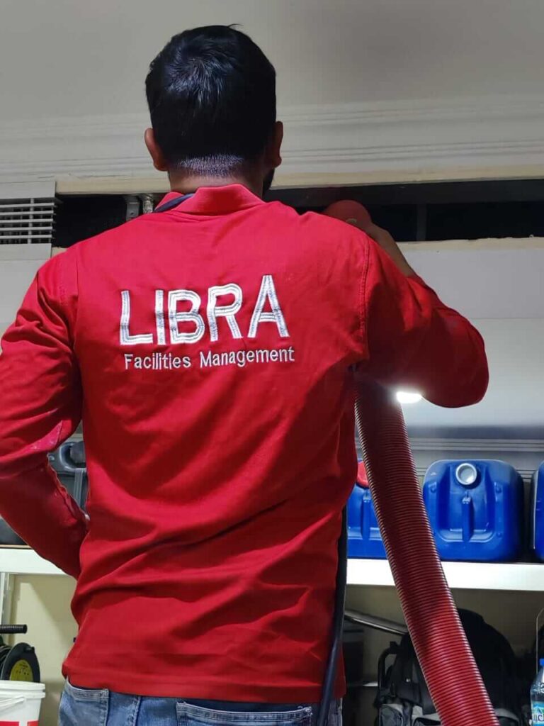 Professional technician from Libra Group UAE performing thorough AC duct cleaning in a Dubai residence, ensuring optimal cooling efficiency and improved indoor air quality-AC Cleaning services in Dubai