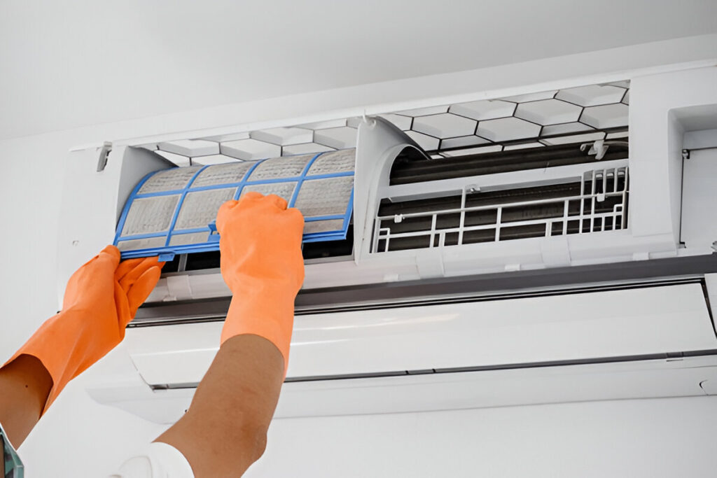 Technician performing air conditioner duct cleaning in Dubai home